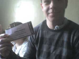 My stepson Teal holding his concert tickets